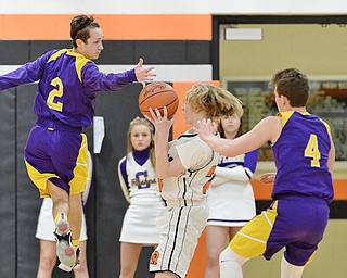 Jeff Lange | The Vindicator  FRI, FEB 19 2016 - Eric Karafa (2) and R.J. Smith pressure Mineral Ridge's Jordan Zupko late in the second quarter of their game at Mineral Ridge High School on Friday.