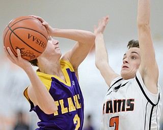 Jeff Lange | The Vindicator  FRI, FEB 19 2016 - Champion's Eric Karafa (left) looks to the basket against Mineral Ridge's Riko Rodriguez during second half action of their game at Mineral Ridge High School on Friday.