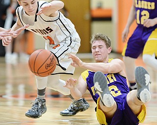 Jeff Lange | The Vindicator  FRI, FEB 19 2016 - Champion's Zach Lindsay (bottom) passes the ball past Mineral Ridge's Riko Rodriguez in the second half of their game on Friday.