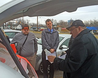      ROBERT K. YOSAY  | THE VINDICATOR..Passing out  the bottles  Social Media Sean Ferguson -Reporter Ed Runyan  takes instructions from Managing Editor Mark Sweetwood..--30-...