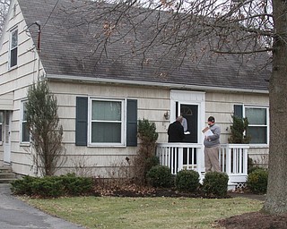      ROBERT K. YOSAY  | THE VINDICATOR..Passing out  the bottles -Graphic Arts Director Robert McFerren and social media reporter Sean Ferguson..