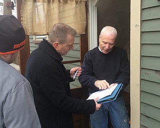      ROBERT K. YOSAY  | THE VINDICATOR..Passing out  the bottles Dave Anderson - Perkinswood goes over the paperwork with Graphic Arts Director Robert McFerren and Social Media Sean Ferguson..--30-...