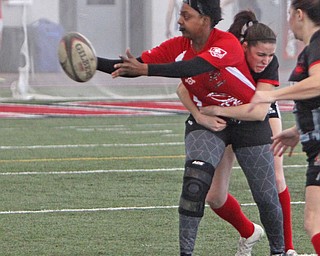 Tim'Aira Gandy of the Youngstown Steel Valley womens rugby team pitches the ball to her teammate while being tackled by Laura Smuts of the Cleveland Iron Maidens team during the first round of the 2016 Thomas "Chris" Smythe Tournament at the Watson and Tressel Training Site on Saturday morning. Dustin Livesay  |  The Vindicator  2/20/16  WATTS