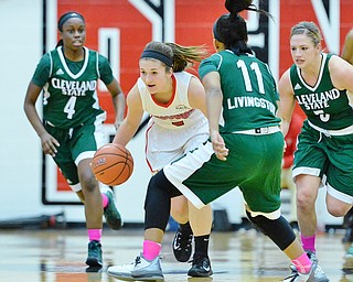 Jeff Lange | The Vindicator  SAT, FEB 20, 2016 - YSU's Alison Smolinski (left center) dribbles the ball through a host of Cleveland State players Adesuwa Aideyman (4), Khayla Livingston (11) and Allison Mitchell (5) during the second quarter of Saturday's basketball game at the Beeghly Center on Saturday.