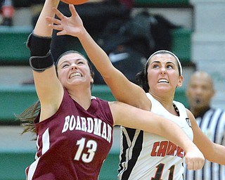Jeff Lange | The Vindicator  MON, FEB 22, 2016 - Boardman's Krista Johnson (13) reaches for a high pass against Canfield's Ashleey Keleel (11) in the third quarter of their basketball game at Lebron James Arena in Akron on Monday.