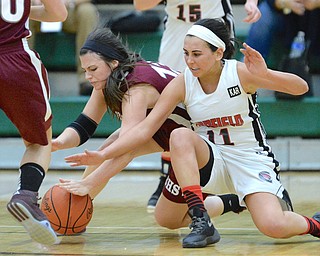 Jeff Lange | The Vindicator  MON, FEB 22, 2016 - Boardman's Krista Johnson (left) fights for a loose ball with Canfield's Ashley Kaleel (11) in the third quarter of their basketball game at Lebron James Arena in Akron Monday night.