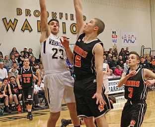 Brookfield's Moataz Rasoul (23) attempts a layup while being defended by Mac White (15) of Mineral Ridge during the first quarter of Tuesday nights matcup at Brookfield High School.  Dustin Livesay   |   The Vindicator  2/24/16  Brookfield High School.