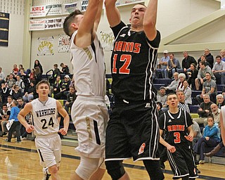 Albert Alli (12) of Mineral Ridge goes up for a layup while being defended by Brookfield's Marc Kraml (2) during the third quarter of Tuesday nights matcup at Brookfield High School.  Dustin Livesay   |   The Vindicator  2/24/16  Brookfield High School.