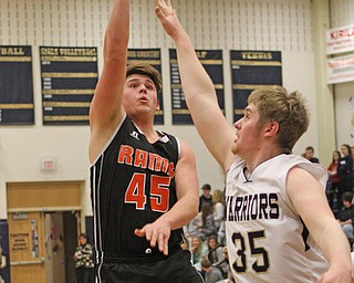 Zane Rummell (45) of Mineral Ridge puts up a hook shot while being defended by Brookfield's Will McDermott (35) during the third quarter of Tuesday nights matcup at Brookfield High School.  Dustin Livesay   |   The Vindicator  2/24/16  Brookfield High School.