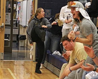 Brookfield High School student, Bailey Drapola, jumps down from the student section in celebration after a nearly full court shot was made in the closing seconds of the third quarter during Tuesday nighsts matchup between Brookfield and Mineral Ridge.  Dustin Livesay   |   The Vindicator  2/24/16  Brookfield High School.