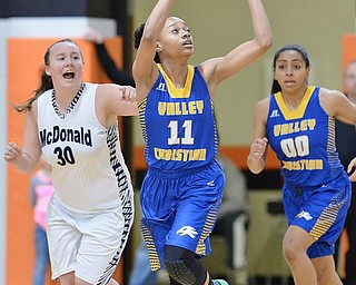 Jeff Lange | The Vindicator  WED, FEB 24, 2016 - Valley Christian's Imane Snyder (11) looks to catch a pass ahead of McDonald's Hannah Donkers (30) and teammate Natalia Mahdee (00) in the first period of their basketball game at Mineral Ridge High School on Wednesday.