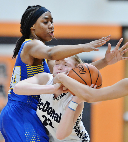Jeff Lange | The Vindicator  WED, FEB 24, 2016 - McDonald's Abbie Matig (22) struggles to maintain possession of the ball as she finds herself under heavy pressure from Valley Christian's Arlivian Cheirs late in the second half of their Division IV district semi final game at Mineral Ridge High School on Wednesday.