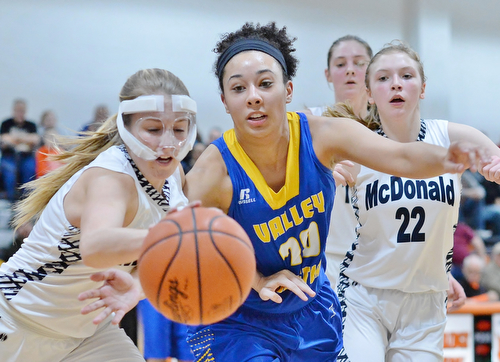 Jeff Lange | The Vindicator  WED, FEB 24, 2016 - McDonald's Sara Joseph (left) battles for a loose ball against Valley Christian's Iliana Suarez in the first half of their basketball game at Mineral Ridge High School Wednesday.