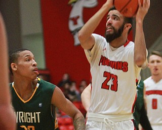 William D Lewis The Vindicator YSU's Francisco Santaigo(23) shoots past WSU's Joe Thomasson (32) during 2-25-16 game at YSU