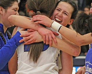Lakeview's Cammie Becker (14) hugs teammate Annie Pavlansky (10) after the Bulldogs defeated Howland High School to win the District Championship at Austintown Fitch High School on Thursday night.   Dustin Livesay  |  The Vindicator  2/25/16  Austintown.
