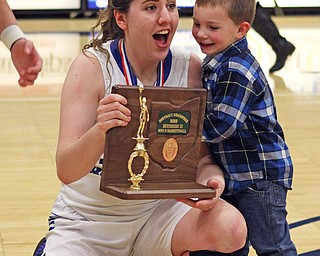 Lakeview's Addie Becker shows the championship trophy to Henry DeToro, son of assitant principal Michael DeToro, after the Bulldogs defeated Howland on Thursday night at Austintown Fitch High School.  Dustin Livesay  |  The Vindicator  2/25/16  Austintown.