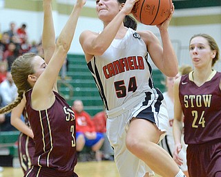 Jeff Lange | The Vindicator  THU, FEB 25, 2016 - Canfield's Serena Sammarone (54) looks to the basket between Stow's Lexi Petit (3) and Lizzie Stefanov (24) in the first half of their Division I district championship game at Akron St. Vincent St. Mary High School on Thursday.