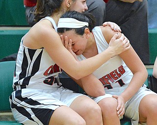 Jeff Lange | The Vindicator  THU, FEB 25, 2016 - Canfield senior Ashley Kaleel (right) is comforted by teammate Serena Sammarone after the Lady Cardinals came up short to the Stow Bulldogs in the Division I district championship game Thursday night in Akron.