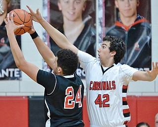 Jeff Lange | The Vindicator  FRI, FEB 26, 2016 - Canfield's Sam Digiacomo (42) attempts to block the shot of Girard's ____ in the first half of their basketball game at Canfield High School Friday night.