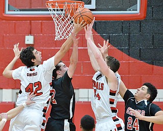 Jeff Lange | The Vindicator  FRI, FEB 26, 2016 - Canfield's Sam Digiacomo (42) and Mason Mangapora (44) fight for a rebound against Girard's Mark Standohar (left center) in the first half of their basketball game in Canfield on Friday.