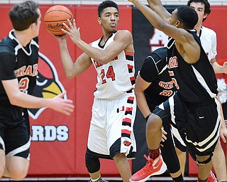 Jeff Lange | The Vindicator  FRI, FEB 26, 2016 - Canfield's Corrion Taylor (24) looks to make a pass over Girard's Isaiah Croff in the first half of Friday night's game in Canfield.