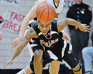 Jeff Lange | The Vindicator  FRI, FEB 26, 2016 - Girard's Isaiah Croff (bottom) battles for the ball with Canfield's Vince Ferrier in the second quarter of Friday night's game in Canfield.