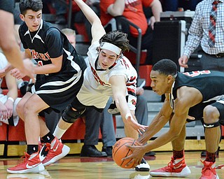 Jeff Lange | The Vindicator  FRI, FEB 26, 2016 - Canfield's Vince Ferrier (center) stretches out to steal the ball away from Girard's Isaiah Croff as Girard's Anthony Graziano looks on during second half action in Canfield Friday night.
