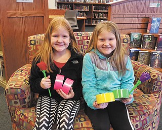 SPECIAL TO THE VINDICATOR | Leetonia Community Public Library, 181 Walnut St., hosted a duct-tape rose craft lesson on Feb. 6. Kayden, left, and Ashlyn Less display their finished duct-tape blooms. For information on library events call 330-427-6635.