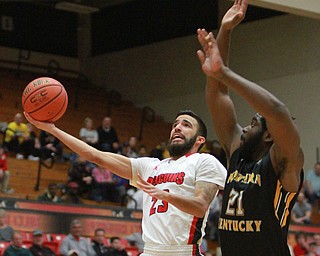William DLewis The Vindicator  YSU's Francisco Santiago (23) shoots past  NKU's Jalen Billups21).