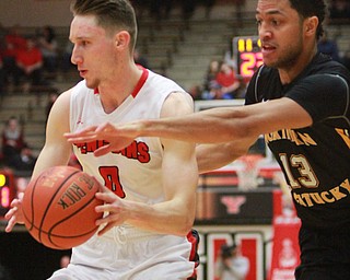 William d Lewis The vindicator  MAtt Donlan(0) drives around NKU's Brennan Gillis(13).