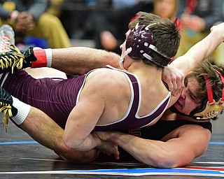 Georgia Polls of Canfield controls he body of Isaac Yoho of Woodridge as the two wrestle on the mat during their 152lb Division II championship bout Saturday night at Alliance High School. SPECIAL TO THE VINDICATOR