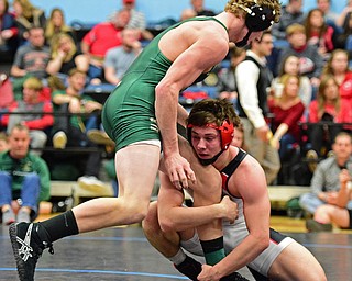 David Crawford of Canfield holds onto the leg of David Heath of St. Vincent-St. Mary during their 160lb Division II championship bout Saturday night at Alliance High School. SPECIAL TO THE VINDICATOR