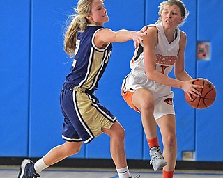 Ashley Sembach #11 of Newton Falls looks to pass the ball while being pressured by McKenzie Drapola #2 of Brookfield during the 1st half of their district final game Saturday afternoon at Ravenna High School. SPECIAL TO THE VINDICATOR