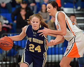Bailey Drapola #24 of Brookfield drives down the base line while being guarded by Gabby Kline #21 of Newton Falls during the 2nd half of their district final game Saturday afternoon at Ravenna High School. SPECIAL TO THE VINDICATOR