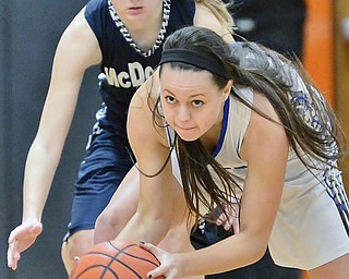 Jeff Lange | The Vindicator  SAT, FEB 27, 2016 - Jackson Milton's Emily Williams (front) picks up a loose ball in front of McDonald's Brenna Rupe during Saturday afternoon's Division IV district championship at Mineral Ridge High School.