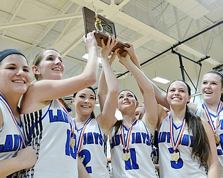 Jeff Lange | The Vindicator  SAT, FEB 27, 2016 - Jackson-Milton Lady Jays hold up the DIV district championship plaque after defeating McDonald Saturday afternoon in Mineral Ridge.