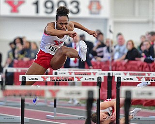 YOUNGSTOWN, OHIO - FEBRUARY 28, 2016: Shatasia Walker of YSU clears a hurdle while teammate Amber Eles rolls on the ground behind he after tripping over a hurdle during the women's 60 meter hurdles final Sunday afternoon during the Horizon League Championship meet at the Watts Training Facility. DAVID DERMER | THE VINDICATOR