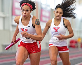 YOUNGSTOWN, OHIO - FEBRUARY 28, 2016: Nina Grambling of YSU turns to sprint after receiving the baton from Taylor McDonald doing the women's 4x400 meter relay during the Horizon League Championship meet at the Watts Training Facility. DAVID DERMER | THE VINDICATOR