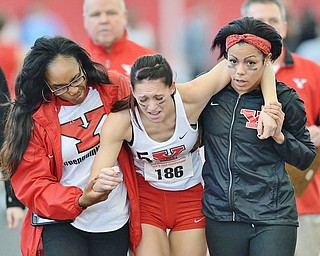 Jeff Lange | The Vindicator  SUN, FEB 28, 2016 - Youngstown's Jen Shiley (center) is helped off the track by alum Alteeka Vanwright (left) and teammate Nina Grambling after she suffered an injury in the final 60 meters of the women's 400 meter run event at the Horizon League Indoor Track Championship in Youngstown Sunday.