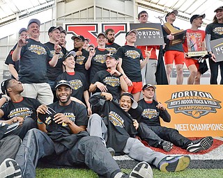 Jeff Lange | The Vindicator  SUN, FEB 28, 2016 - Members of the men's track team celebrate after the Penguins won the Horizon League indoor track championship Sunday in Youngstown.