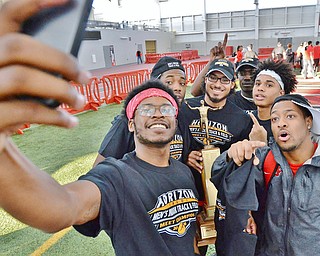 Jeff Lange | The Vindicator  SUN, FEB 28, 2016 - (From left) Tyree Ballenger, David Rivers III, Arnaldo Morales, Caleb Lloyd and Lasanders Washington take a selfie with the Horizon League men's indoor track championship trophy Sunday in Youngstown.