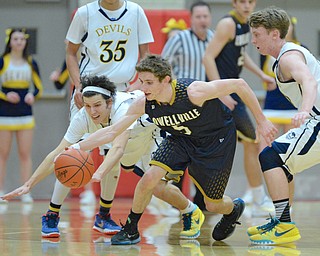 Jeff Lange | The Vindicator  MON, FEB 29, 2016 - McDonald's Jake Reckard (left) dives to steal the ball away from Lowellville's Tyler Barone (5) early in their district semifinal in Struthers Monday.