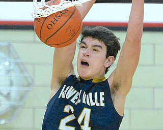 Jeff Lange | The Vindicator  MON, FEB 29, 2016 - Lowellville's Cole Beatty hangs on the rim as he slams the ball for two in the first half of the Rockets' loss to McDonald in the district semifinal game in Struthers on Monday.