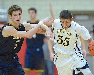 Jeff Lange | The Vindicator  MON, FEB 29, 2016 - Devils' Braedon Poole (35) drives past Lowellville's Tyler Barone (5) late in the second half of their district semifinal at Struthers Fieldhouse on Monday.