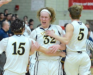 Jeff Lange | The Vindicator  MON, FEB 29, 2016 - McDonald seniors Matt Howard (center), Jake Reckard (left) and Zack Fedysky celebrate after the Devils defeated Lowellville 56-53 in the district semifinal at Struthers High School on Monday.