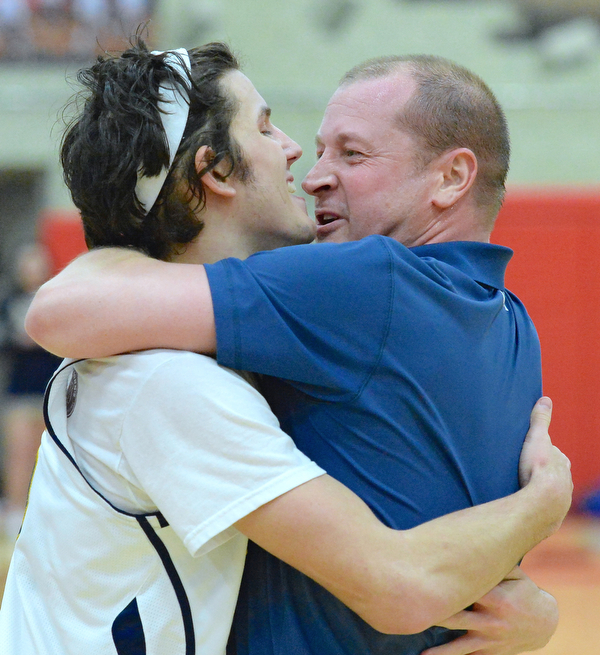 Jeff Lange | The Vindicator  MON, FEB 29, 2016 - Head coach of the McDonald Blue Devils, Jeff Rasile, wraps his arms around senior Jake Reckard in celebration of their victory over Lowellville on Monday.