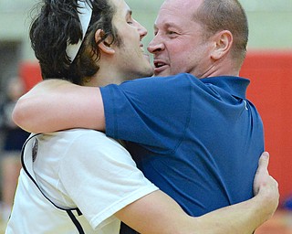 Jeff Lange | The Vindicator  MON, FEB 29, 2016 - Head coach of the McDonald Blue Devils, Jeff Rasile, wraps his arms around senior Jake Reckard in celebration of their victory over Lowellville on Monday.