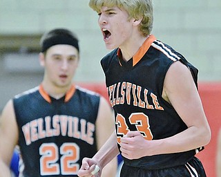 Jeff Lange | The Vindicator  TUE, MAR 1, 2016 - Wellsville's Justin Miller (33) celebrates a three-point shot early in the Tigers' DIV district semifinal against Lisbon at the Struthers Fieldhouse on Tuesday.