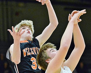 Jeff Lange | The Vindicator  TUE, MAR 1, 2016 - Wellsville's Justin Miller (left) reaches out for a rebound over Lisbon's Austin Rutecki in the second period of Tuesday night's DIV district semifinal at the Struthers Fieldhouse.