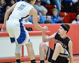 Jeff Lange | The Vindicator  TUE, MAR 1, 2016 - Lisbon's Seth Stokes (0) helps up Wellsville opponent Jake Green after the two collided during second half action of their DIV district semifinal in Struthers on Tuesday.